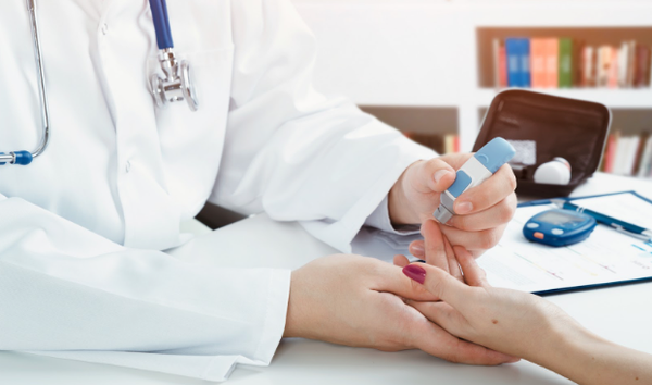 Doctor checking blood sugar level. doctor patient diabetes lancet glucometer blood glucose office concept 