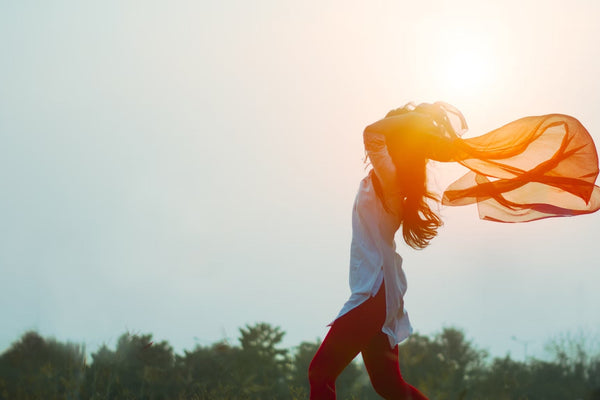 woman spreading her hair during sunset